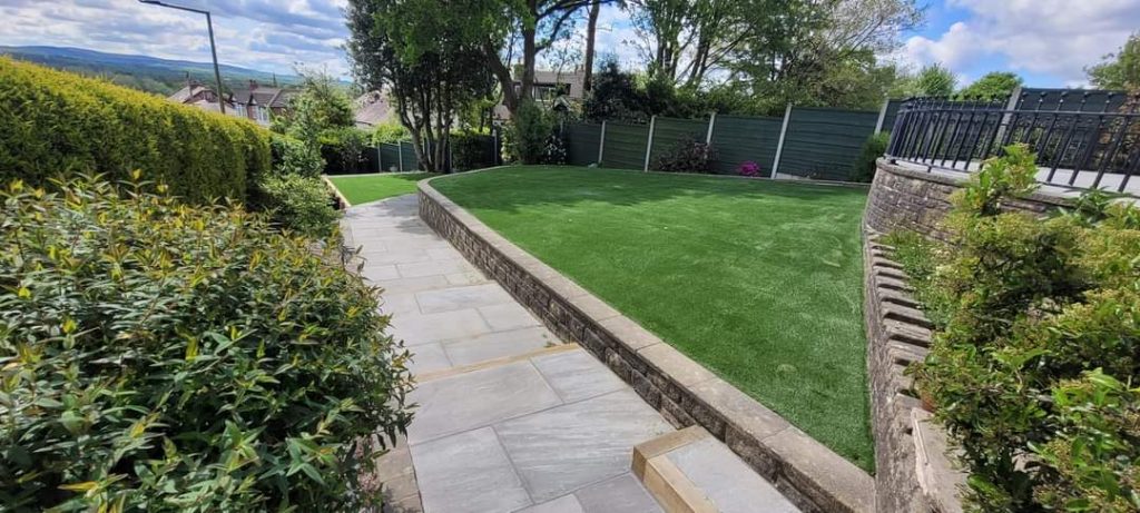 Full Garden renovation, retaining wall with Sleepers, Indian Stone Kandla Grey, Luxury Artificial Grass